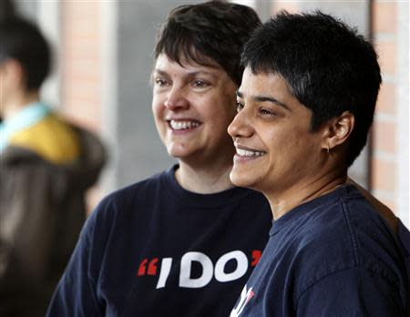 Same-sex marriage supporters Laurel Gregory (L) and Shilpi Banerjee, who are the first in line for marriage licenses, smile in Portland, Oregon May 19, 2014. REUTERS/Steve Dipaola