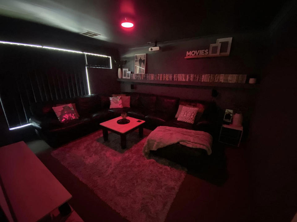 A lounge bathed in dark red light, to replicate a cinema