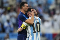 Argentina's head coach Lionel Scaloni kisses Argentina's Lionel Messi, right, at the end of the World Cup quarterfinal soccer match between the Netherlands and Argentina, at the Lusail Stadium in Lusail, Qatar, Saturday, Dec. 10, 2022. (AP Photo/Natacha Pisarenko)