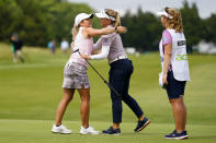 Brooke M. Henderson, of Canada, center, gets a hug from Lindsey Weaver-Wright, left, after defeating Weaver-Wright in a playoff at the ShopRite LPGA Classic golf tournament, Sunday, June 12, 2022, in Galloway, N.J. (AP Photo/Matt Rourke)
