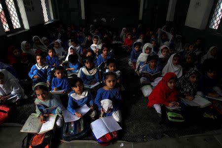 Girls attend their daily class at a government school in Peshawar October 29, 2014. REUTERS/Fayaz Aziz