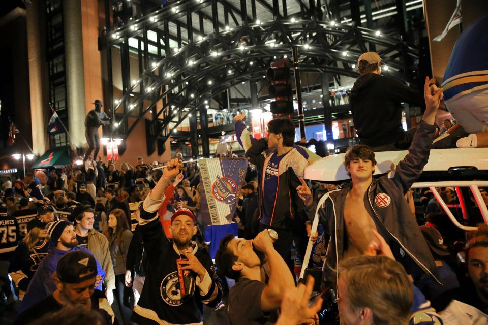 St. Louis Blues fans celebrate outside Busch Stadium in St. Louis, where a watch party had been held for Game 7 of the NHL hockey Stanley Cup Final between the Blues and the Boston Bruins in Boston, Wednesday, June 12, 2019. The Blues won the title. (David Carson/St. Louis Post-Dispatch via AP)