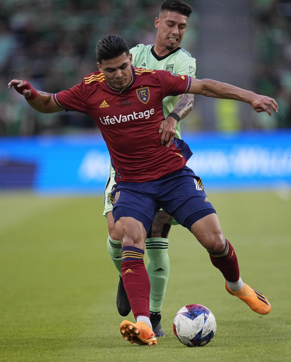 Real Salt Lake defender Brayan Vera moves the ball past Austin FC midfielder Emiliano Rigoni, rear, during the first half of an MLS soccer match in Austin, Texas, Saturday, June 3, 2023. (AP Photo/Eric Gay)