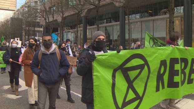 People march in Vancouver on Saturday Feb. 27, 2021 as part of a Extinction Rebellion organized event to draw attention to inaction over climate change in Canada. (Doug Kerr/CBC - image credit)
