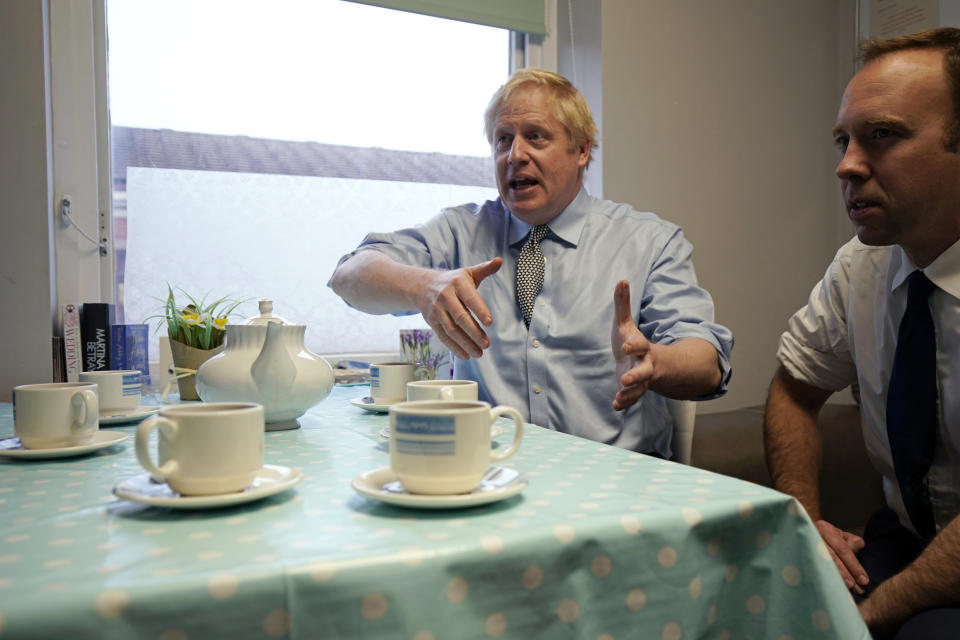 Prime Minister Boris Johnson, right, and Secretary of State for Health and Social Care Matt Hancock have tea with members of staff as they visit Bassetlaw District General Hospital, during their General Election campaign in Worksop, England, Friday, Nov. 22, 2019. (Christopher Furlong/Pool photo via AP)