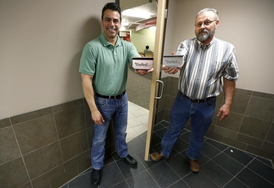 Mike Sewell, left, Ron Ely and another business partner, not pictured, invented and brought to market the StepNpull, a hands-free way to open bathroom doors.