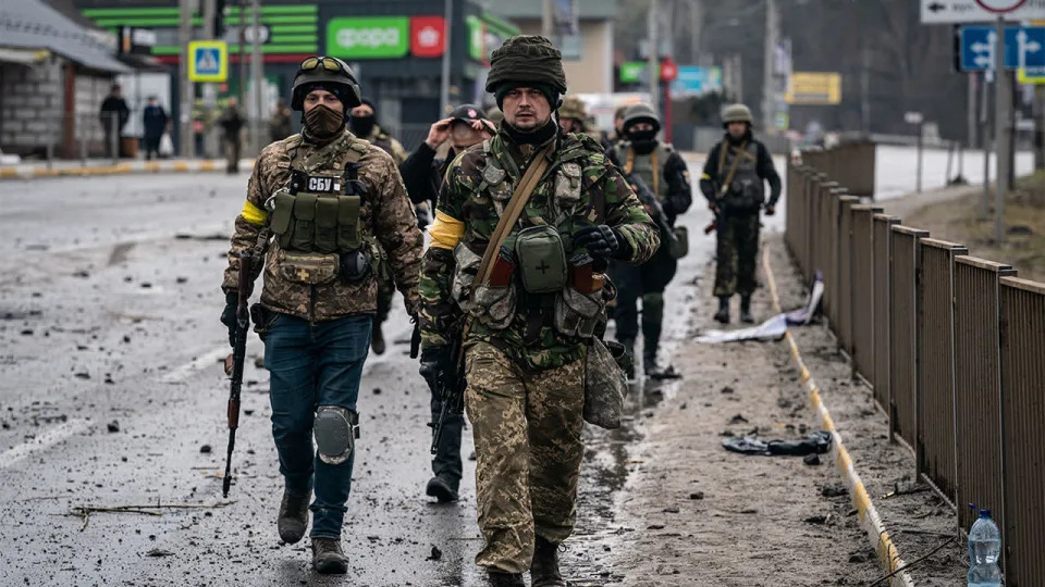 Ukrainian soldiers are seen near a collapsed bridge that was the target of a Russian missile, near the town of Irpin, Ukraine, on March 3, 2022. <span class="copyright">Wolfgang Schwan/Anadolu Agency via Getty Images</span>