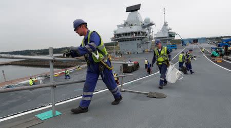 The British aircraft carrier HMS Queen Elizabeth, undergoes preparations for its maiden voyage, in its dock at Rosyth, in Scotland, Britain June 21, 2017. Photograph taken on June 21, 2017. REUTERS/Russell Cheyne