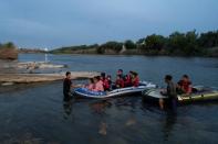 FILE PHOTO: Asylum-seeking migrants cross the Rio Grande river in Roma