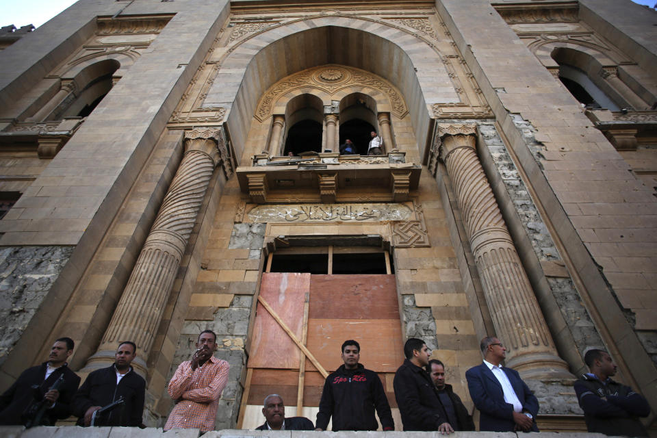 Egyptian security officers stand guard at the entrance of the Museum of Islamic Art after an explosion at the Egyptian police headquarters in downtown Cairo, Friday, Jan. 24, 2014. Egypt's antiquities minister says the car bombing that struck the main police headquarters in Cairo earlier in the day has caused major damage to the nearby Islamic art museum.(AP Photo/Khalil Hamra)