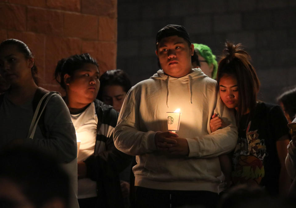 <p>Mourners stand in silence during a candlelight vigil at the University of Nevada Las Vegas (UNLV) for victims of a mass shooting in Las Vegas, Nevada, USA, 02 October 2017. (Photo: Eugene Garcia/EPA-EFE/REX/Shutterstock) </p>