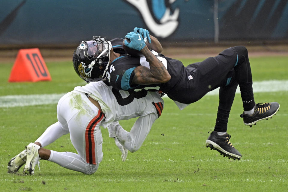 Jacksonville Jaguars wide receiver Keelan Cole Sr. (84) is stopped by Cleveland Browns cornerback Kevin Johnson, left, after a reception during the first half of an NFL football game, Sunday, Nov. 29, 2020, in Jacksonville, Fla. (AP Photo/Phelan M. Ebenhack)