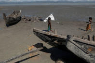 Children collect wood from remnants of some 20 boats that ferried Rohingya refugees fleeing violence in Myanmar, which were destroyed by Bangladeshi authorities the night before, at Shah Porir Dwip near Cox's Bazar, Bangladesh October 4, 2017. REUTERS/Damir Sagolj