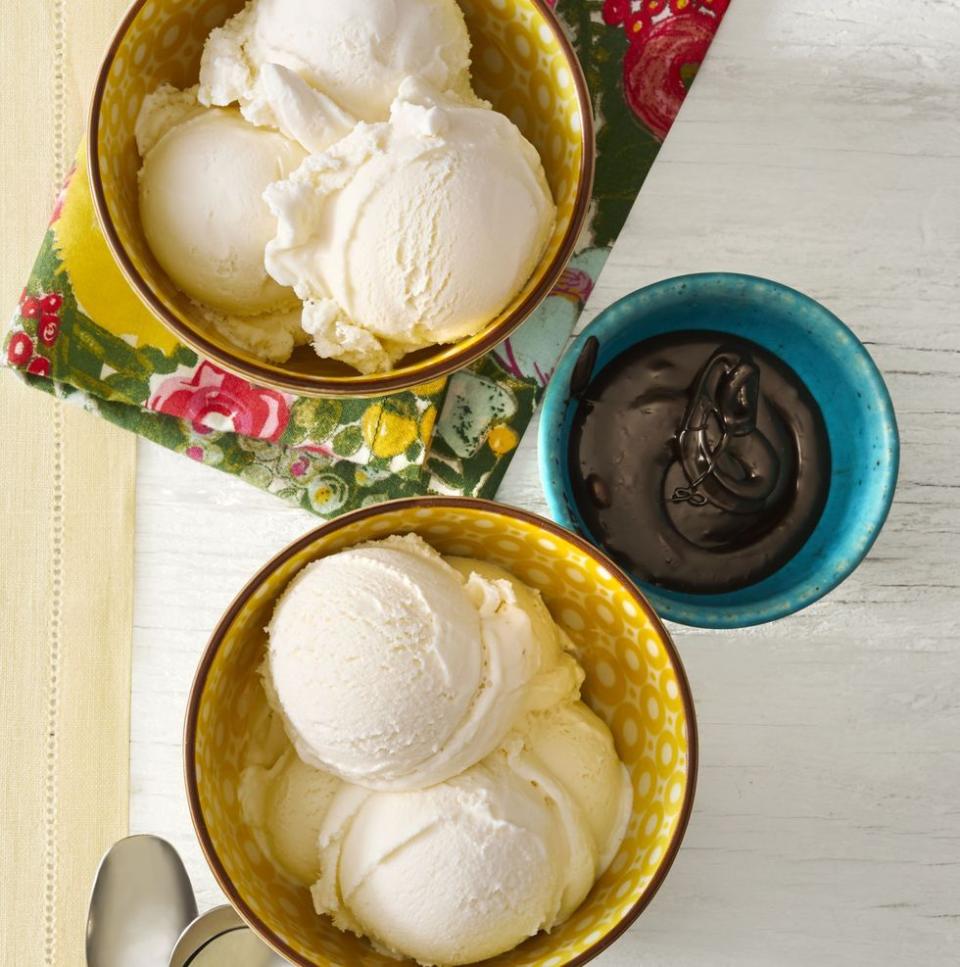 vanilla bean ice cream with hot fudge sauce in yellow and blue bowls