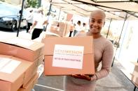 <p>Tiffany Haddish helps donate Chromebook computers to students in foster care during a drive-through giveaway event at city councilmember Herb Wessons's district office in L.A. on Thursday. </p>