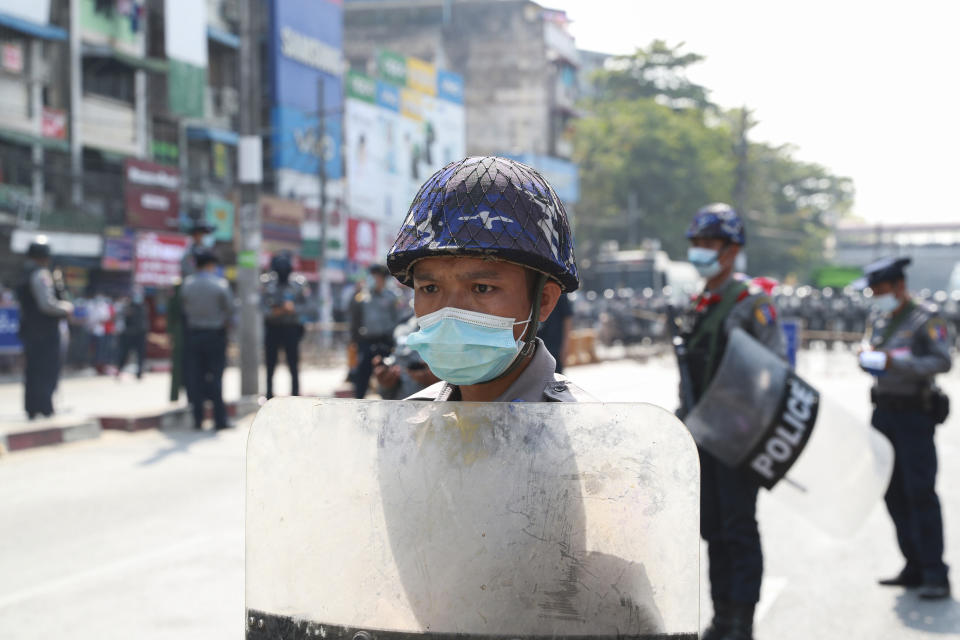 A policeman in riot gear stands guard during a protest rally in Yangon, Myanmar, on Feb. 6, 2021. Protests in Myanmar against the military coup that removed Aung San Suu Kyi’s government from power have grown in recent days despite official efforts to make organizing them difficult or even illegal. (AP Photo)