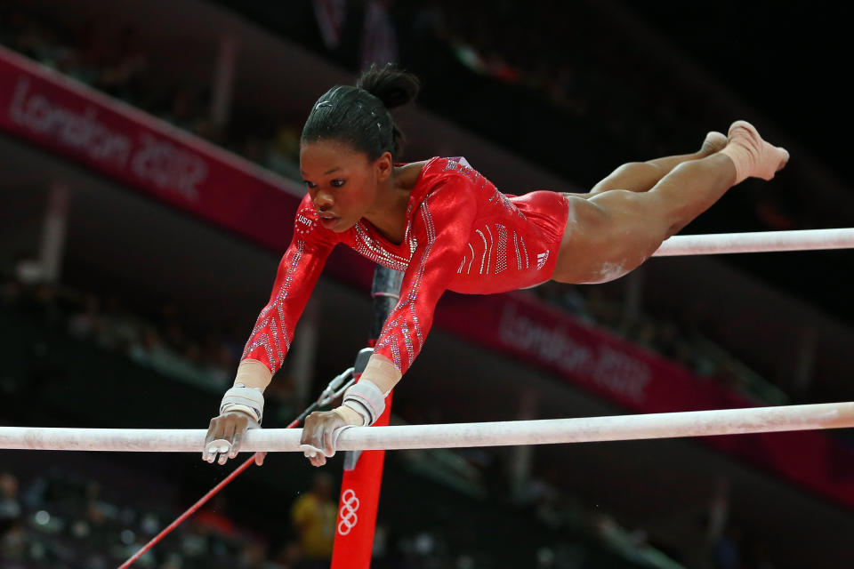 Gabby Douglas competes on the uneven bars in the artistic gymnastics women's team final at the London Olympics on July 31, 2012.&nbsp; (Photo: Ronald Martinez via Getty Images)