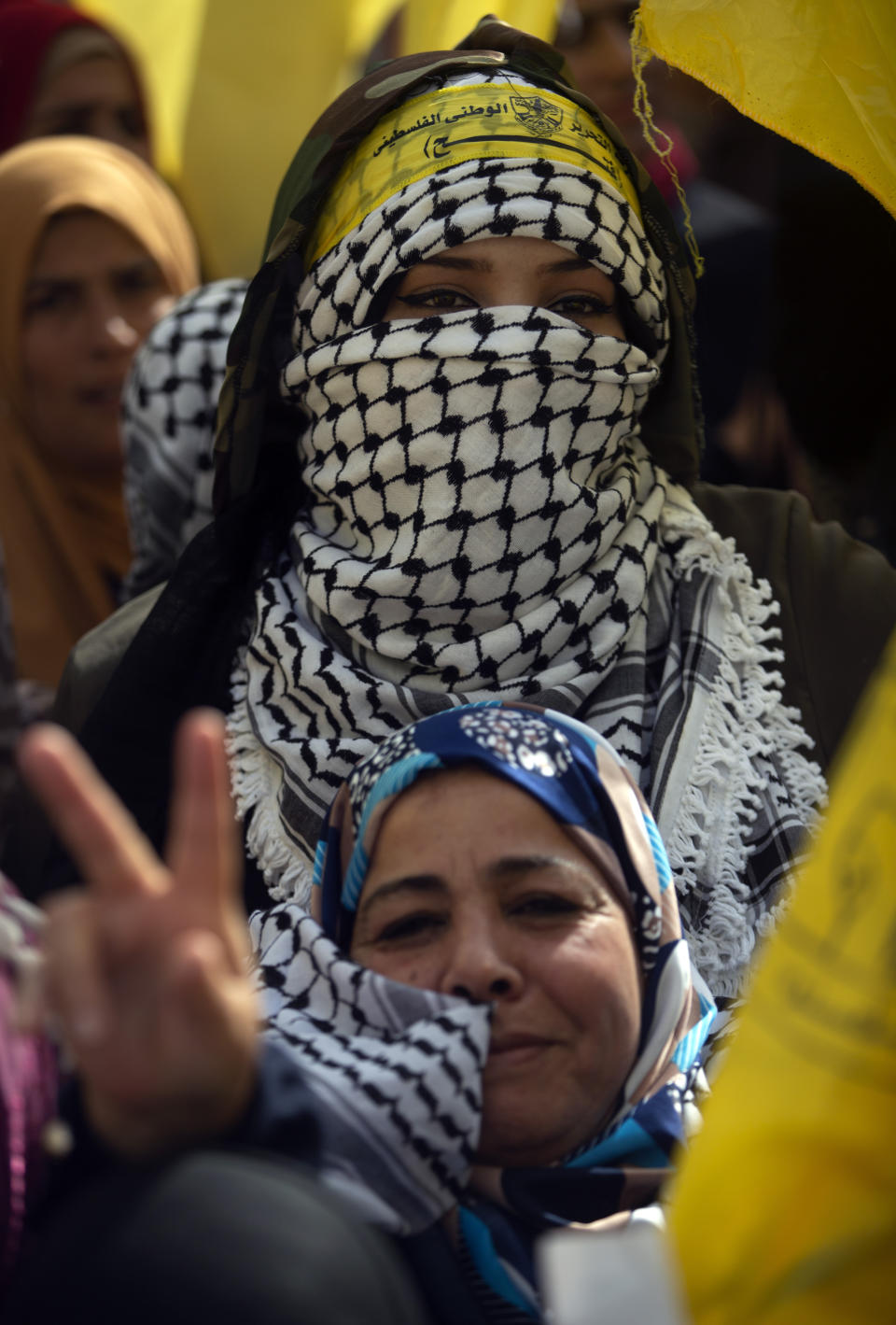 Palestinian women celebrate during a rally marking the 55th anniversary of the Fatah movement founding, in Gaza City, Wednesday, Jan. 1, 2020. Fatah is a secular Palestinian party and former guerrilla movement founded by the late Palestinian leader Yasser Arafat, in Gaza City, Wednesday, Jan. 1, 2020. (AP Photo/Khalil Hamra)