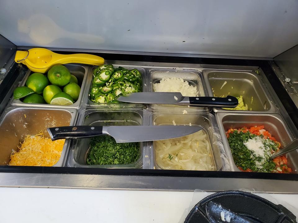 A small bar of toppings takes up a corner on the Burrito Bistro NC food trailer in Mebane. Owner Hugo Sosa makes his pickled onions and pico de gallo condiments.