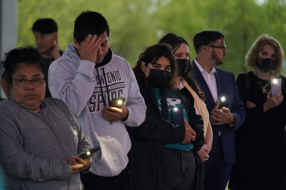 Members of the community take part in a vigil for the dozens of people have been found dead Monday in a semitrailer containing suspected migrants, Tuesday, June 28, 2022, in San Antonio. (AP Photo/Eric Gay)