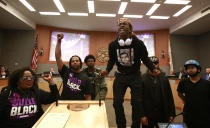 FILE — In this Tuesday, March 27, 2018 file photo, Stevante Clark stands on a desk as he shouts the name of his brother Stephon Clark, who was fatally shot by police a week earlier, during a meeting of the Sacramento City Council in Sacramento, Calif. The shooting death of Clark helped spur the passage of two laws to take effect in 2020 giving California one of the nation's most comprehensive approaches to deterring shootings by police. One changes the legal standard for when police can use deadly force, while the companion law increased officers' training on how to handle confrontations. (AP Photo/Rich Pedroncelli, File)