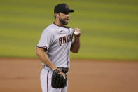 Arizona Diamondbacks' Madison Bumgarner stands on the mound after giving up a solo home run to Miami Marlins shortstop Miguel Rojas during the first inning of a baseball game, Thursday, May 6, 2021, in Miami. (AP Photo/Lynne Sladky)