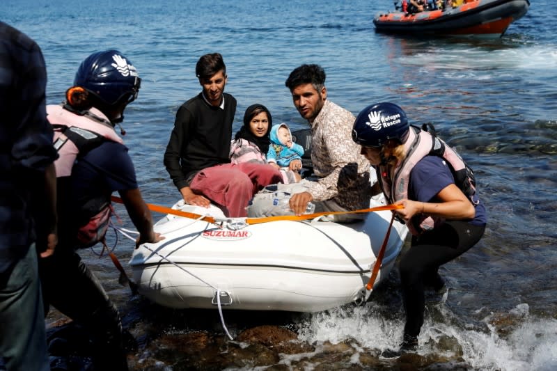 FILE PHOTO: A small inflatable boat carrying migrants from Afghanistan is towed by rescuers of the Refugee Rescue NGO, near Skala Sikamias, on the island of Lesbos