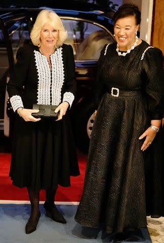 <p>AARON CHOWN/POOL/AFP via Getty Images</p> Queen Camilla is greeted by Baroness Scotland of Asthal at the Commonwealth Day Reception at Marlborough House in London, on March 11, 2024.