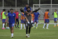 Iran's national soccer team goalkeeper Ali Reza Beiranvand, bottom, teammate Mehdi Shiri, top and Mehdi Torabi, left, move towards the media after a training session in Tehran, Iran, Wednesday, Sept. 14, 2022. Iran will face the United States, England and Wales during Qatar's FIFA World Cup. (AP Photo/Vahid Salemi)