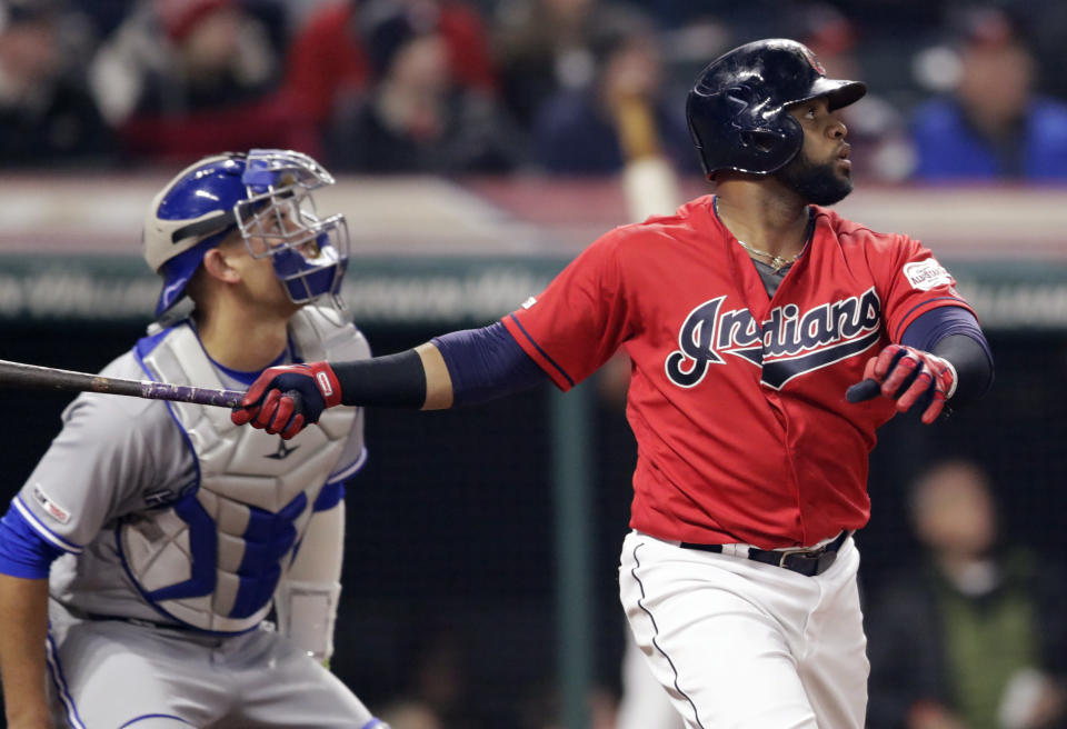 Cleveland Indians' Carlos Santana watches his solo home run off Toronto Blue Jays relief pitcher Joe Biagini during the ninth inning of a baseball game Friday, April 5, 2019, in Cleveland. Blue Jays catcher Luke Maile is at left. The Indians won 3-2. (AP Photo/Tony Dejak)