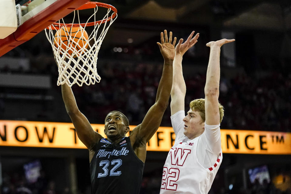 Marquette's Darryl Morsell (32) shoots against Wisconsin's Steven Crowl (22) during the first half of an NCAA college basketball game Saturday, Dec. 4, 2021, in Madison, Wis. (AP Photo/Andy Manis)