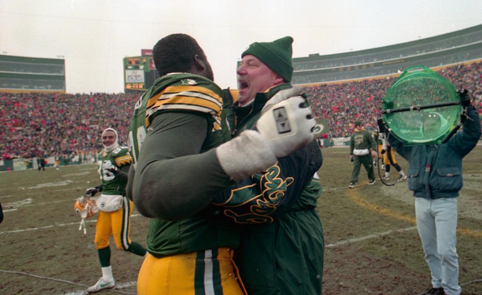 Green Bay coach Mike Holmgren hugs Sean Jones after the Packers beat the Pittsburgh Steelers.