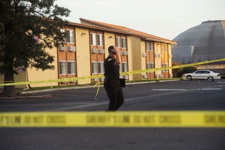 Sacramento County Sheriff Lieutenant Palmer walks through a Motel 6 parking lot where Sheriff's Deputy Danny Oliver was killed in Sacramento, California on October 24, 2014. REUTERS/Noah Berger