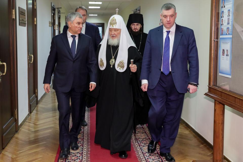 FILE - In this handout photo released by the press service of the State Duma, Russian Orthodox Patriarch Kirill, center, flanked by Vyacheslav Volodin, left, speaker of the Lower House of Parliament, and Leonid Slutsky, chairman of the State Duma's International Affairs Committee, right, arrives to address lawmakers in Moscow, Russia, Thursday, Jan. 26, 2023. Although abortion in Russia is still legal and widely available, new restrictions are being considered as President Vladimir Putin takes an increasingly socially conservative turn and seeks to reverse the country's declining population. (The State Duma, The Federal Assembly of The Russian Federation Press service via AP, File)