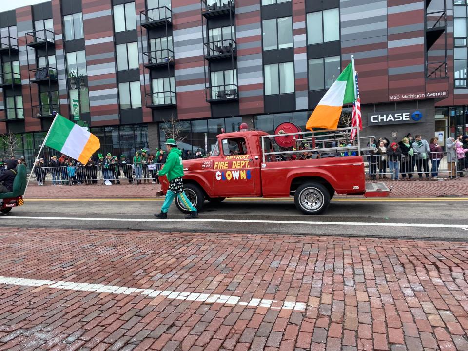 The Detroit Fire Department clowns walks along Michigan Avenue in Corktown during the annual St. Patrick's Day Parade Sunday.