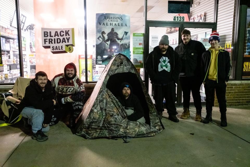 A group of Black Friday shoppers wait outside GameStop in Fort Gratiot for the store to open Friday, Nov. 27, 2020. Most of the group had been waiting outside the store since Wednesday for a new Xbox Series X or PlayStation 5.