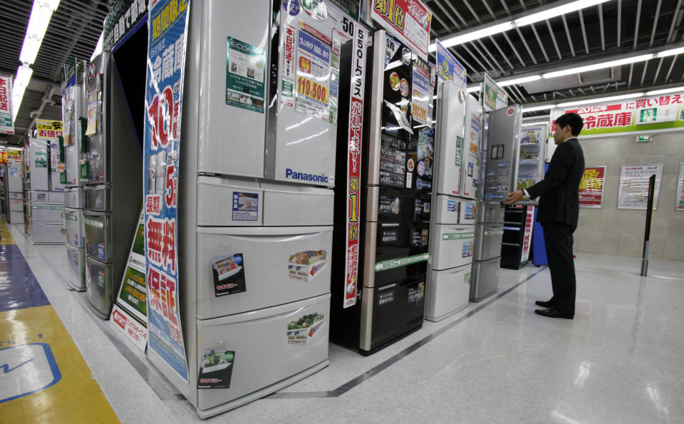 A man inspects a refrigerator at a discount electric store in Tokyo Friday, Oct. 26, 2012. Japan's Cabinet approved a 423 billion yen ($5.3 billion) economic stimulus package on Friday, moving to fend off recession amid signs the recovery in the world's third biggest economy is faltering. The decision coincided with news of a 0.1 percent fall in the consumer price index in September, adding to pressure on the central bank to ease policies to help fight deflation, or falling prices, which can hinder economic growth. (AP Photo/Koji Sasahara)