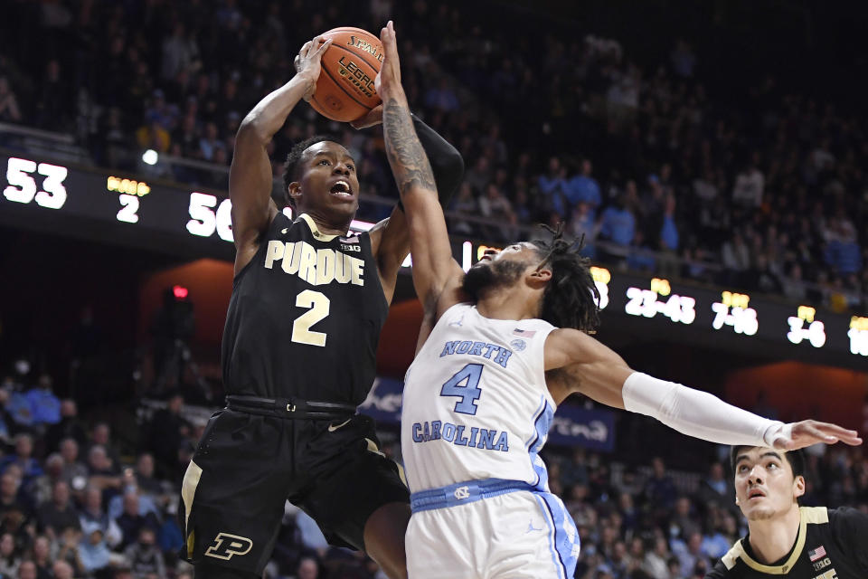 Purdue's Eric Hunter Jr. (2) shoots over North Carolina's R.J. Davis (4) in the second half of an NCAA college basketball game, Saturday, Nov. 20, 2021, in Uncasville, Conn. (AP Photo/Jessica Hill)