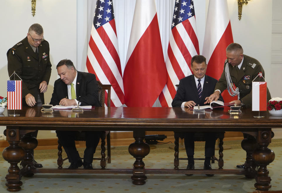 US Secretary of State Mike Pompeo, left, and Poland's Minister of Defence Mariusz Blaszczak sign the US-Poland Enhanced Defence Cooperation Agreement in the Presidential Palace in Warsaw, Poland, Saturday Aug. 15, 2020. Pompeo is on a five day visit to central Europe. (Janek Skarzynski/Pool via AP)