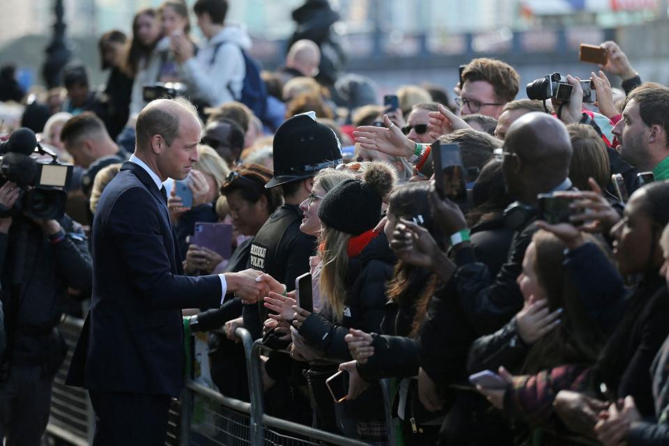 Britain's Prince William, Prince of Wales talks with members of the public waiting in the queue to pay their respects to Queen Elizabeth II, Lying-in-State at the Palace of Westminster, in London on September 17, 2022. - Queen Elizabeth II will lie in state in Westminster Hall inside the Palace of Westminster, until 0530 GMT on September 19, a few hours before her funeral, with huge queues expected to file past her coffin to pay their respects. (Photo by ISABEL INFANTES / AFP) (Photo by ISABEL INFANTES/AFP via Getty Images)