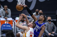 Sacramento Kings guard Buddy Hield (24) blocks a shot by Atlanta Hawks forward Danilo Gallinari (8) during the first quarter of an NBA basketball game in Sacramento, Calif., Wednesday, March 24, 2021. (AP Photo/Hector Amezcua)