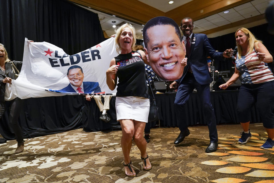 Supporters of republican conservative radio show host Larry Elder gather as polls close for the California gubernatorial recall election Tuesday, Sept. 14, 2021, in Costa Mesa, Calif. The rare, late-summer election, which challenged California Governor Gavin Newsom, has emerged as a national battlefront on issues from COVID-19 restrictions to climate change. (AP Photo/Ashley Landis)