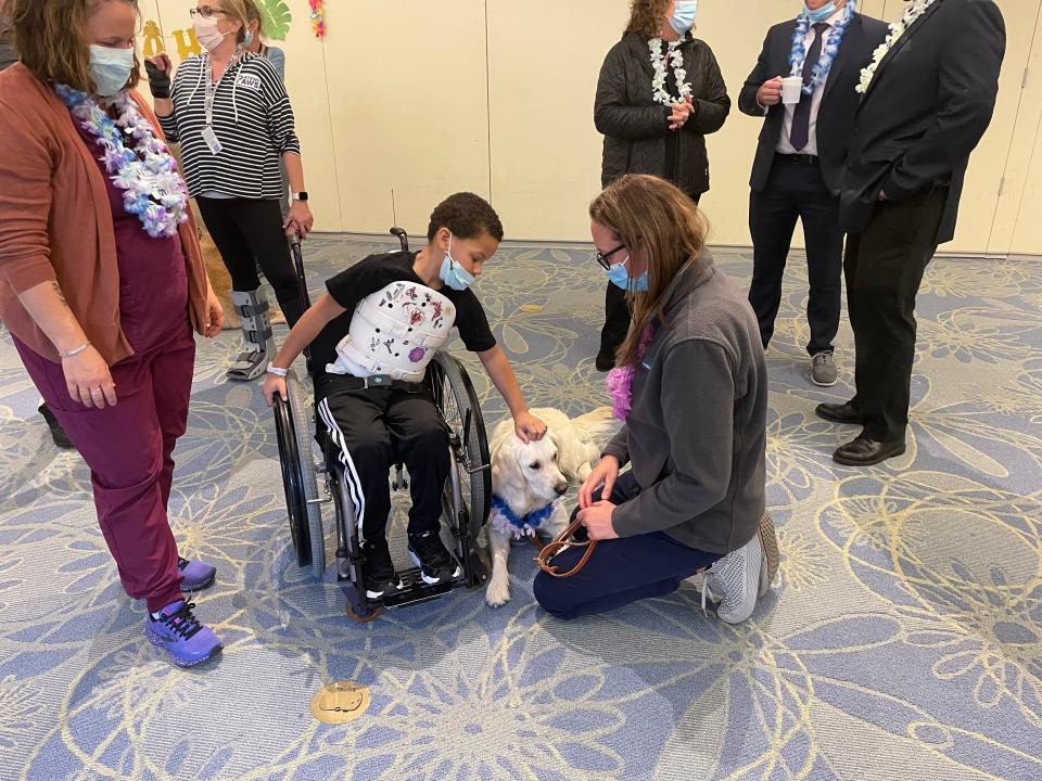Here with Mason, Maui, is the newest staff member at Children's Specialized Hospital and ready to get to work. With "big paws to fill," the 22-month-old English Cream Golden Retriever is the facility's new therapy dog and will continue the work of Burton, who passed in June after an illness.