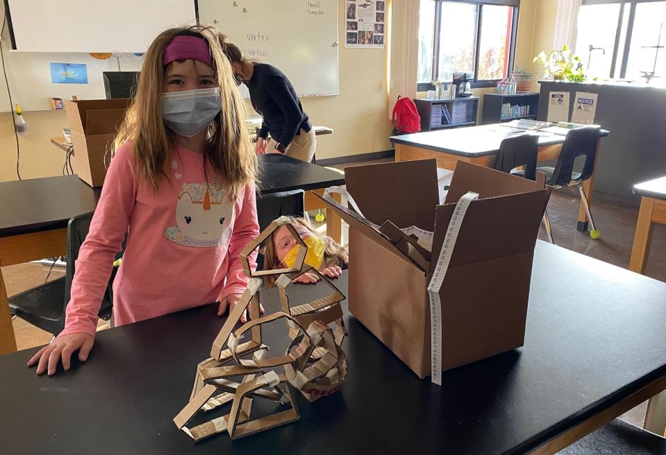 Students in the Creative STEM Club at Patagonia Elementary pose with a geometry project. The shapes will become part of the functional headdress that students construct for their superhero character and will help them solve a social or environmental problem in their community. (Mat Bevel Company)