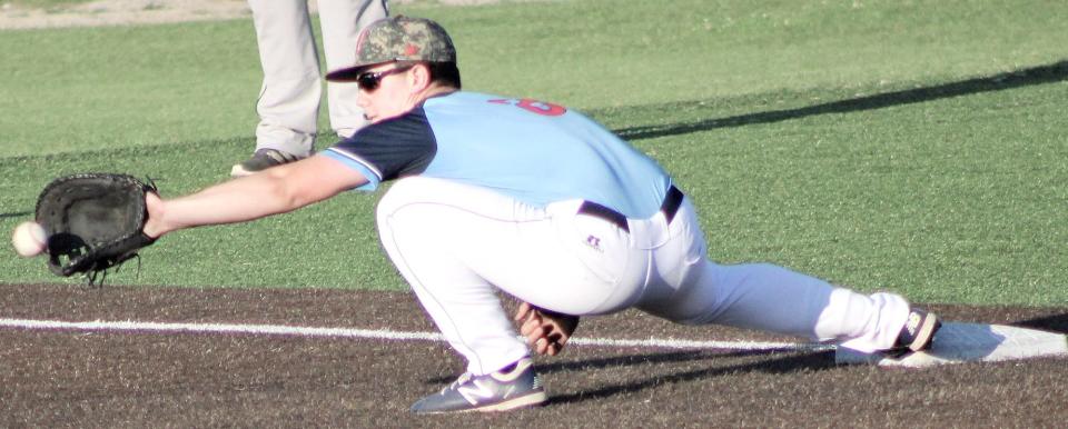 Third baseman Harrison Clark extends to snare the ball during Bartlesville Doenges Ford Indians action last summer.