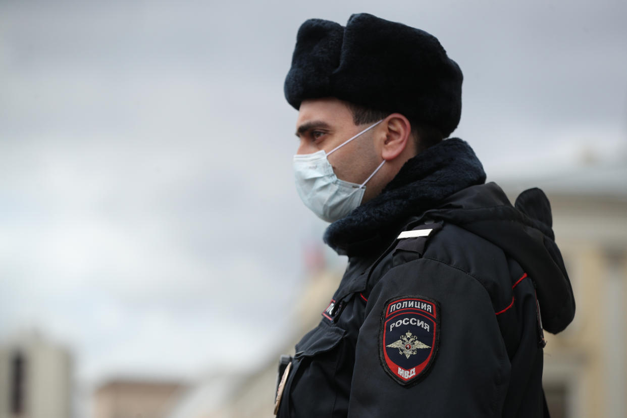 MOSCOW, RUSSIA - APRIL 15, 2020: A police officer in a face mask stands guard at the entrance to a station of the Moscow Underground (metro) during the pandemic of the novel coronavirus disease (COVID-19). Police stop commuters entering and exiting stations of the Moscow Underground for ID checks to see if they have permission to travel. On 13 April 2020, the Moscow government introduced a digital permit system aimed at further restricting movement. Under the new scheme, which becomes mandatory from 15 April, people need to apply for permits to travel on public transport or a vehicle around the city. Since 30 March 2020, Moscow has been on lockdown. As of 15 April 2020, Russia has reported more than 21,100 confirmed cases of the novel coronavirus infection, with more than 13,000 confirmed cases in Moscow. Mikhail Tereshchenko/TASS EDITORIAL USE ONLY; NO COMMERCIAL USE; NO ADVERTISING (Photo by Mikhail Tereshchenko\TASS via Getty Images)