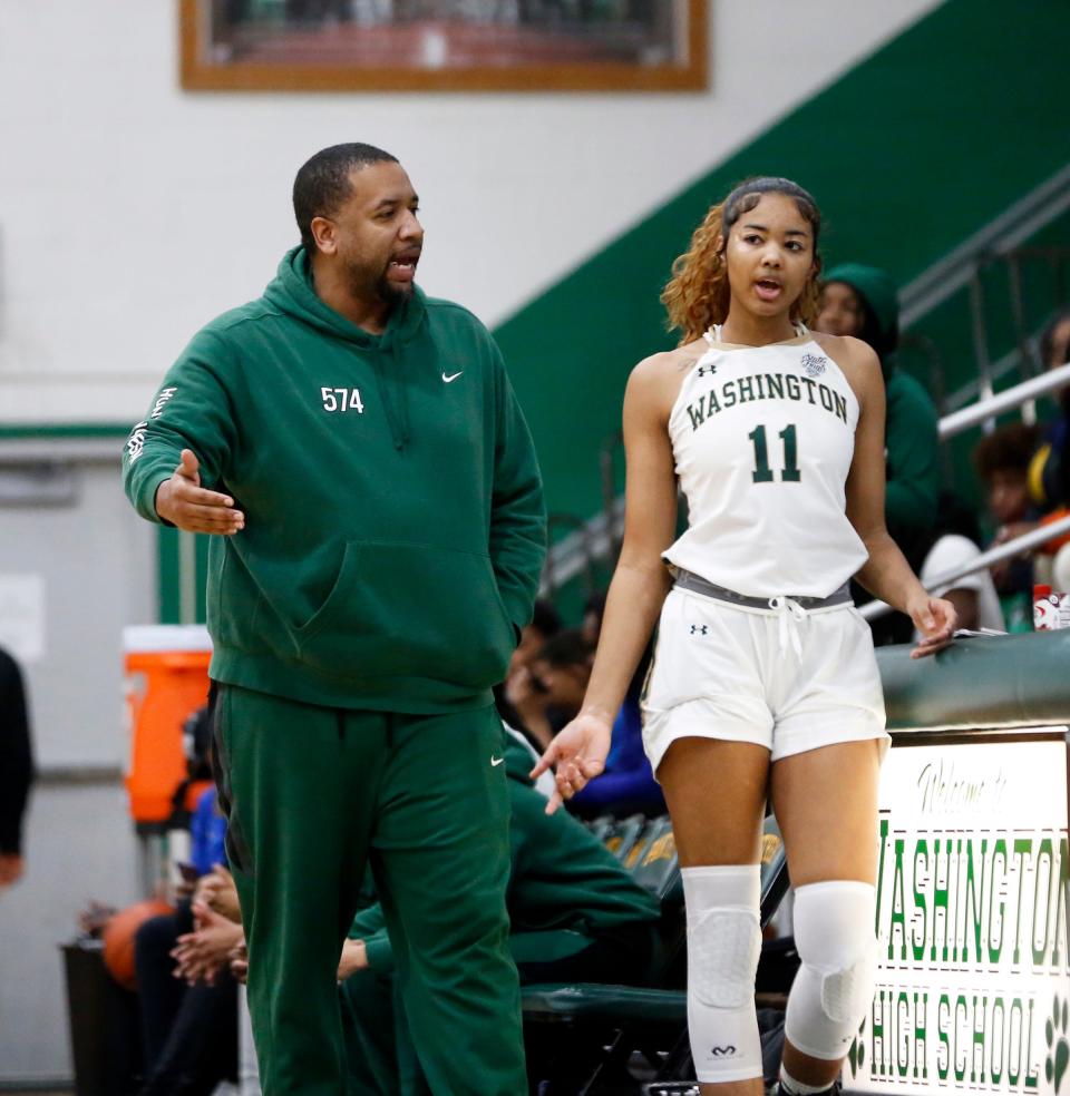 South Bend Washington head coach Steven Reynolds, left, talks to his daughter and junior player on the team, Kira, during a girls basketball game against Bolingbrook Saturday, Jan. 6, 2024, at Washington High School.