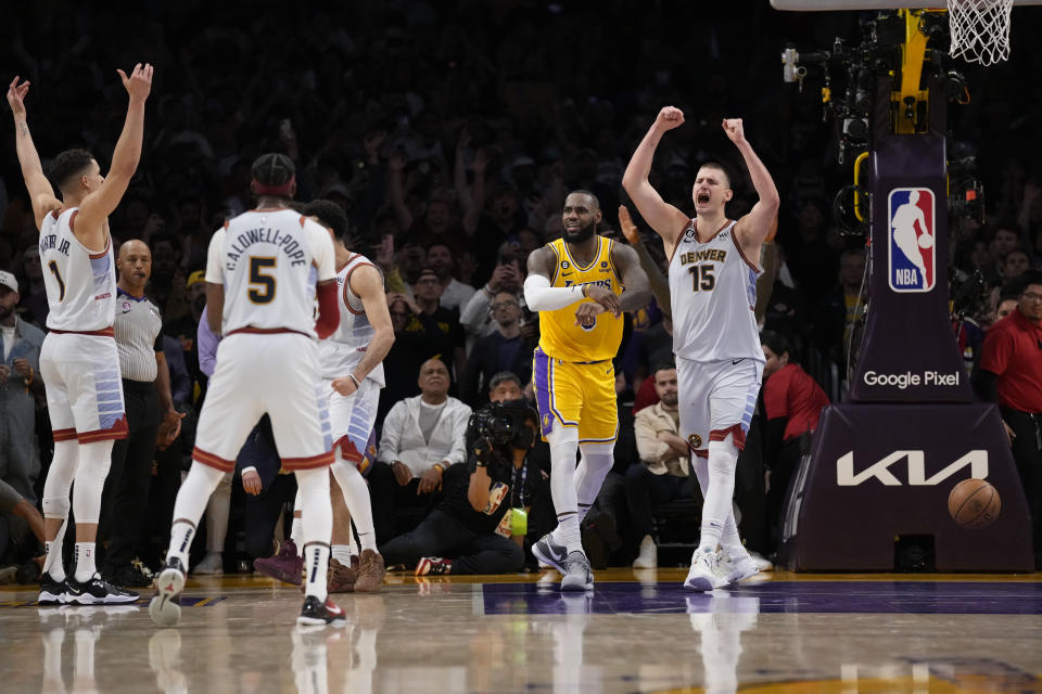 Denver Nuggets center Nikola Jokic (15) celebrates after Los Angeles Lakers forward LeBron James, center, missed a layup attempt as time expired in the second half of Game 4 of the NBA basketball Western Conference Final series Monday, May 22, 2023, in Los Angeles. Denver won 113-111 to win the series. (AP Photo/Ashley Landis)