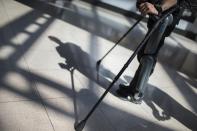 22-year-old Errol Samuels from Queens, New York, who lost the use of his legs in 2012 after a roof collapsed onto him at an off-campus house party near where he was attending college in upstate New York, pauses in the sun-filled atrium while walking with the ReWalk electric powered exoskeletal suit during a therapy session at the Mount Sinai Medical Center in New York City March 26, 2014. Made by the Israeli company Argo Medical Technologies, ReWalk is a computer controlled device that powers the hips and knees to help those with lower limb disabilities and paralysis to walk upright using crutches. Allan Kozlowski, assistant professor of Rehabilitation Medicine at Icahn School of Medicine at Mount Sinai hospital, where patients like Samuels are enrolled in his clinical trials of the ReWalk and another exoskeleton, the Ekso (Ekso Bionics) hopes machines like these will soon offer victims of paralysis new hope for a dramatically improved quality of life and mobility. The ReWalk is currently only approved by the U.S. Food and Drug Administration (FDA) for use in rehabilitation facilities like at Mount Sinai, as they weigh whether to approve the device for home use as it already is in Europe. Picture taken March 26, 2014. REUTERS/Mike Segar
