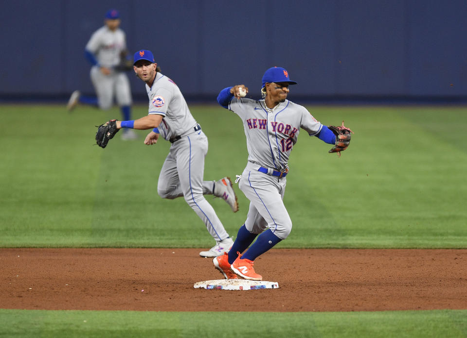 New York Mets shortstop Francisco Lindor (12) turns a double play during the first inning of a baseball game against the Miami Marlins, Sunday, April 2, 2023, in Miami. Miami Marlins' Luis Arraez (not shown) grounded into the double play. (AP Photo/Michael Laughlin)